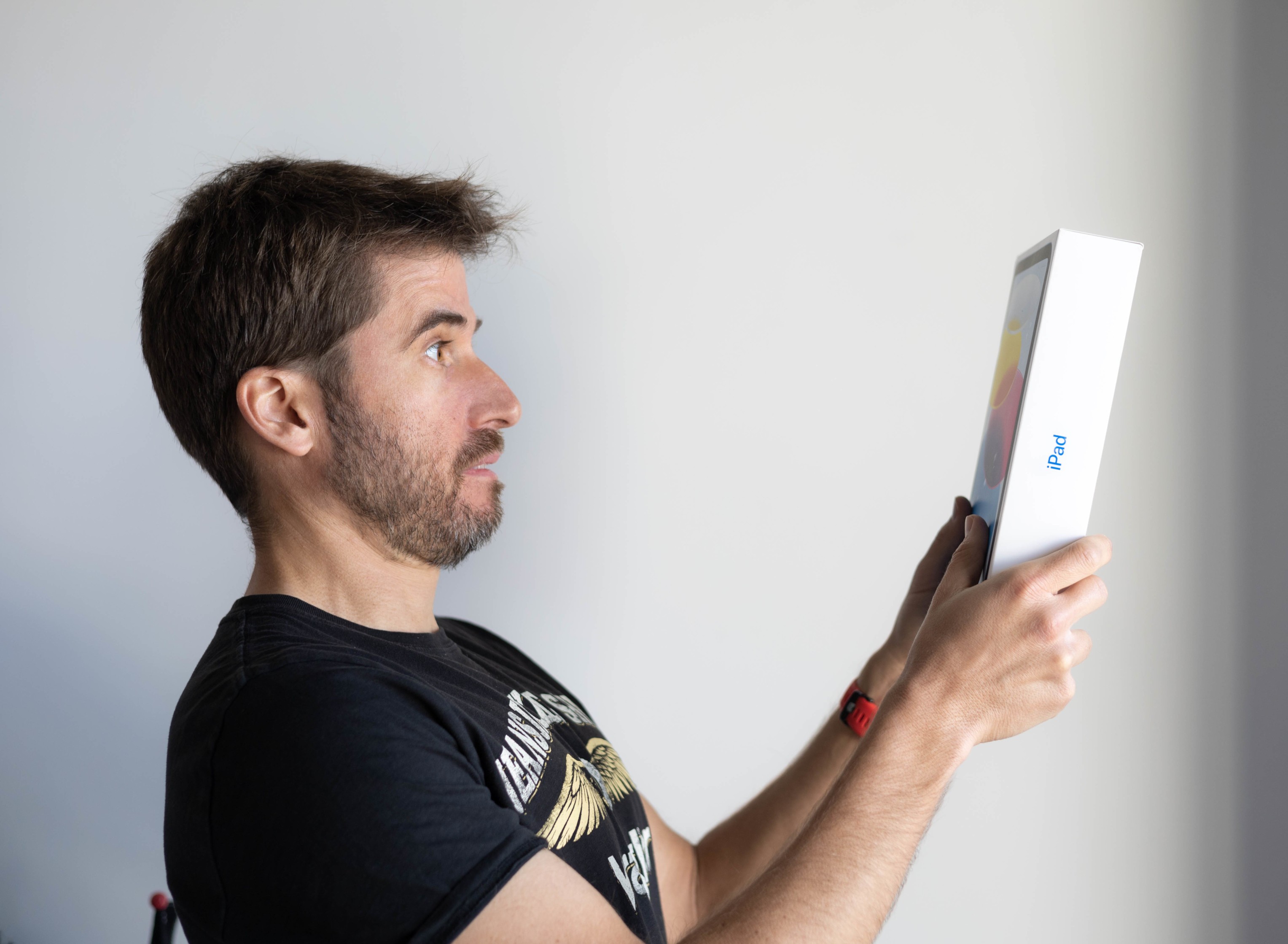 An image of Marc holding an iPad with mixed feelings